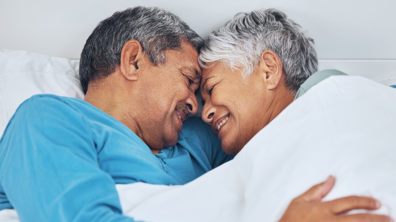 senior man and woman in bed