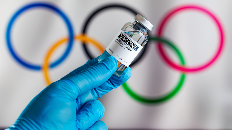 drug bottle in front of olympic rings