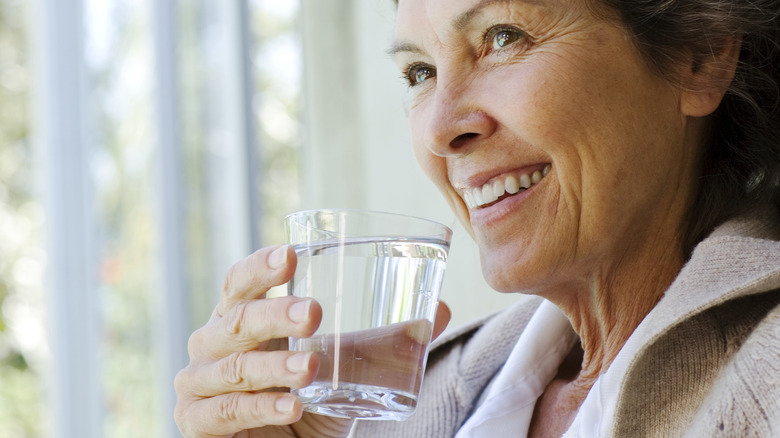 older woman drinking water