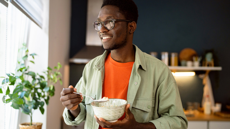 man eating bowl of oatmeal