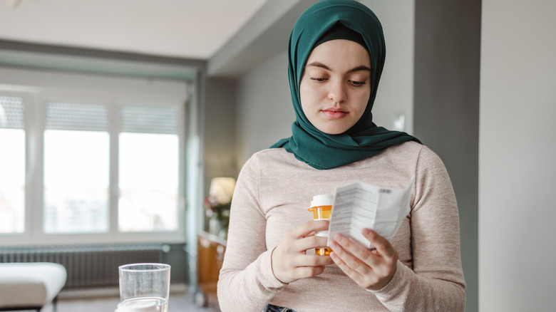 Woman reading prescription drug warning