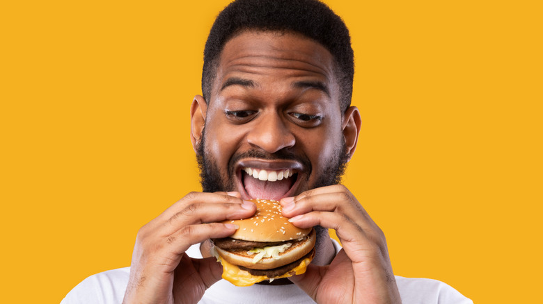 Man eating cheeseburger