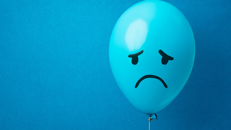 blue balloon with sad face