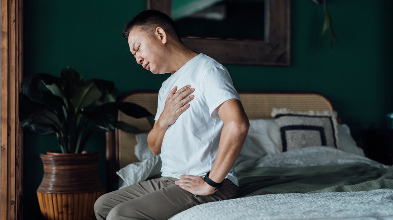 Man in bed with chest pain