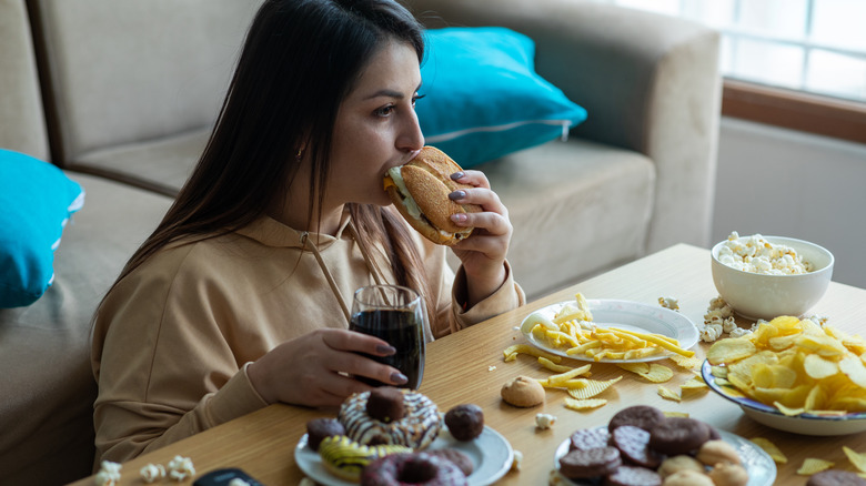 Woman binging on junk food 