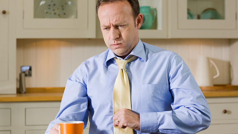 Man at table feeling sick