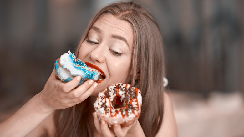 Woman eating doughnuts