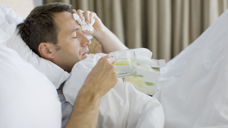 Man in bed feeling sick