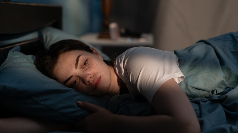 Woman lying in bed wide awake