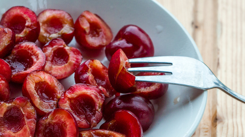 Sliced cherries in a bowl