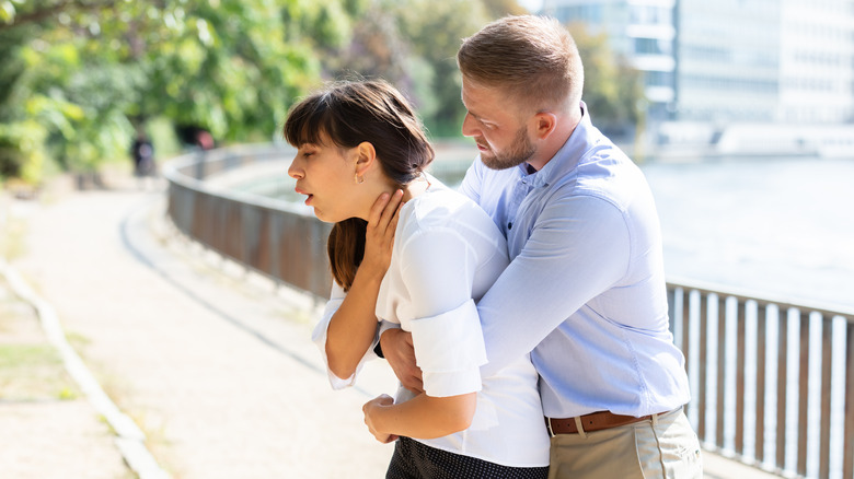 Man helping choking woman