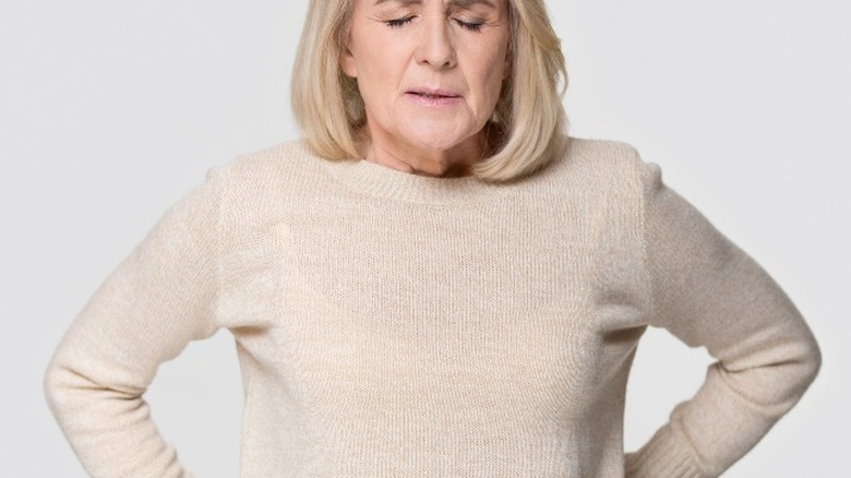 Woman with hemorrhoid pain