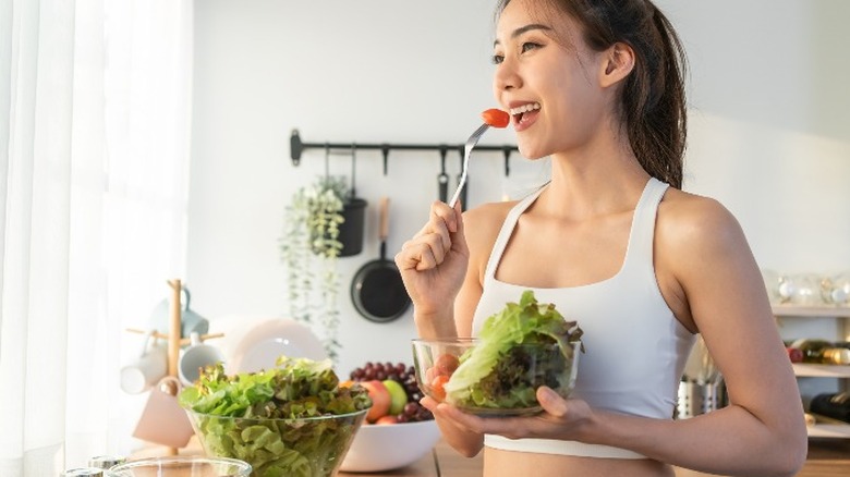 Fit woman eating vegetables