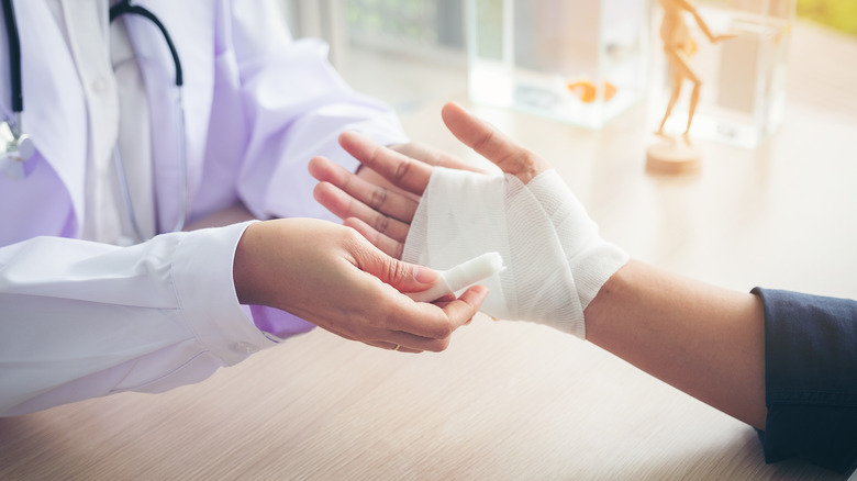 doctor bandaging hand