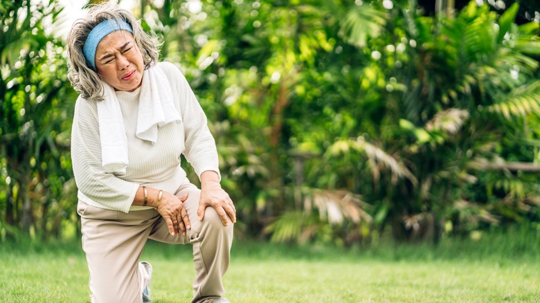 woman kneeling in pain