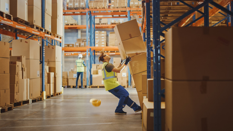 worker falling with cardboard boxes