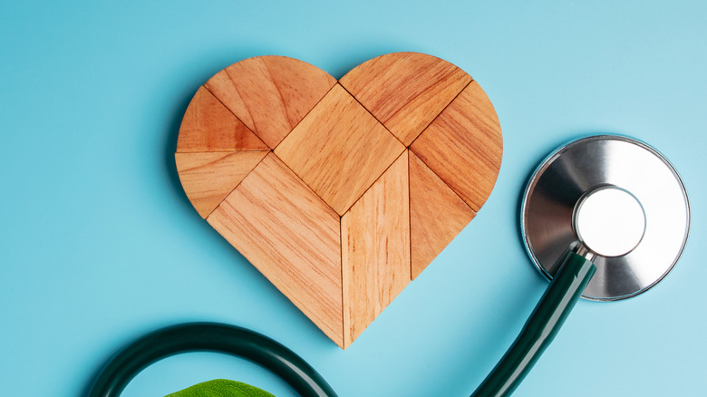 wooden heart stethoscope blue background