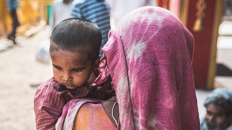 homeless mother carrying child