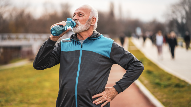 Man drinking water after run