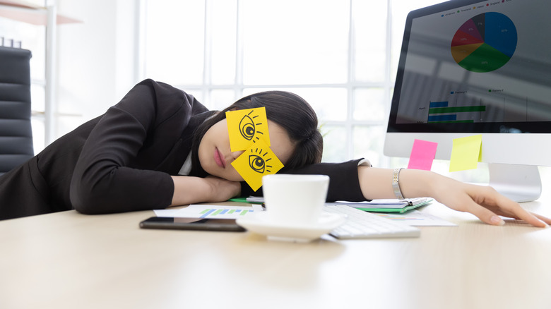 woman collapsed on desk