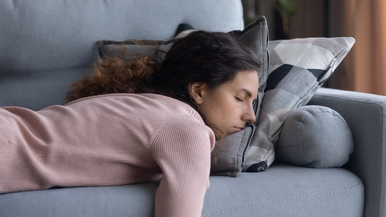 Woman sleeping on couch at home