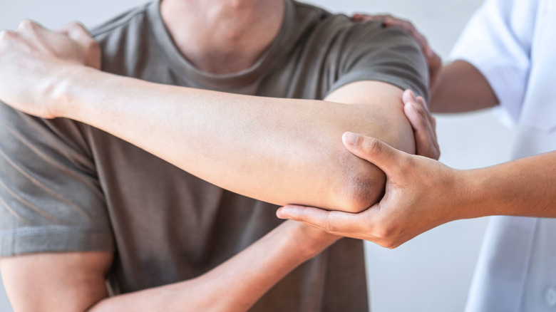 Man with arm injury getting massage