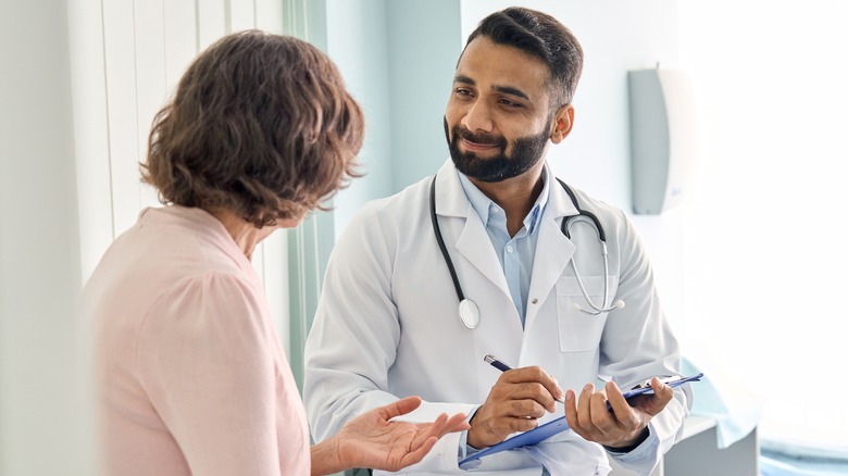 Patient consulting with smiling doctor