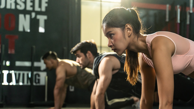 woman in a fitness class doing a plank demonstrating strength