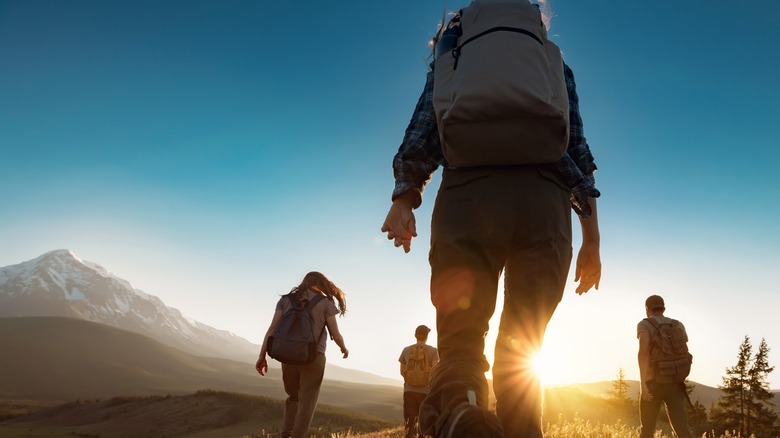 a group of people going on a hike in the wilderness demonstrating endurance