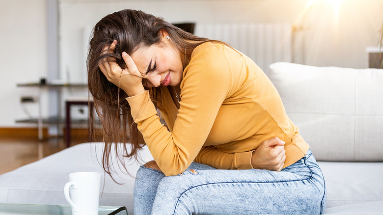 woman clutching stomach