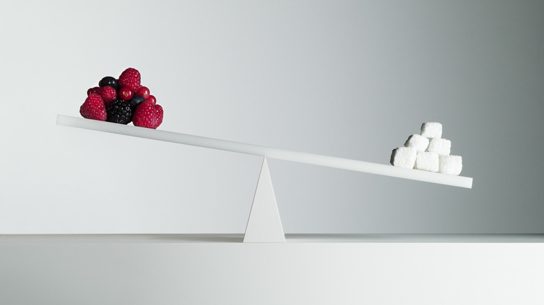 Berries vs. white sugar on a scale