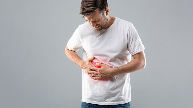 man holding liver in pain