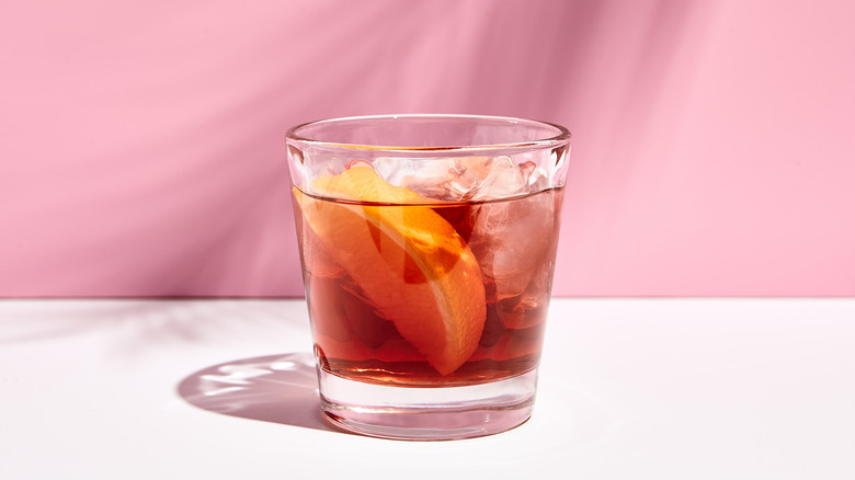 negroni in glass with pink background