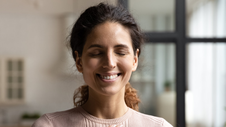 woman happy holding hands at heart 