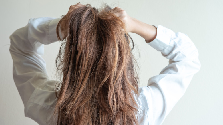 back of woman holding hair