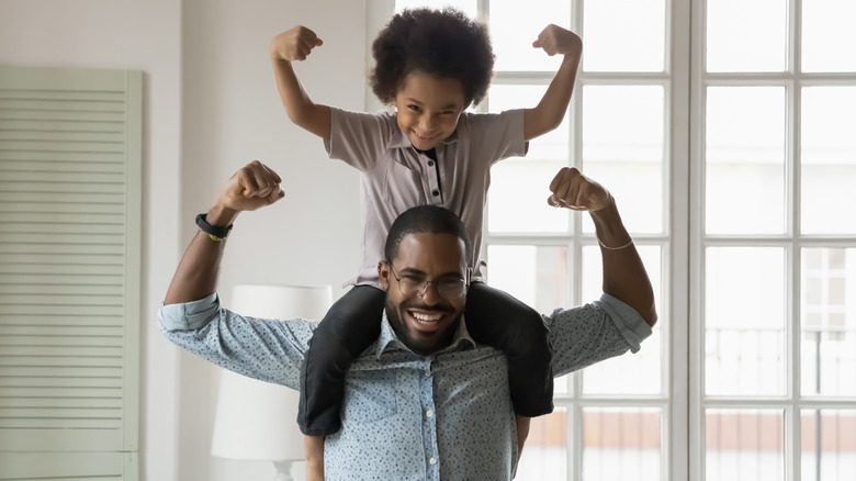 Man holding son on shoulders