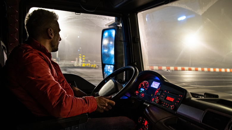 Truck driver driving on highway at night