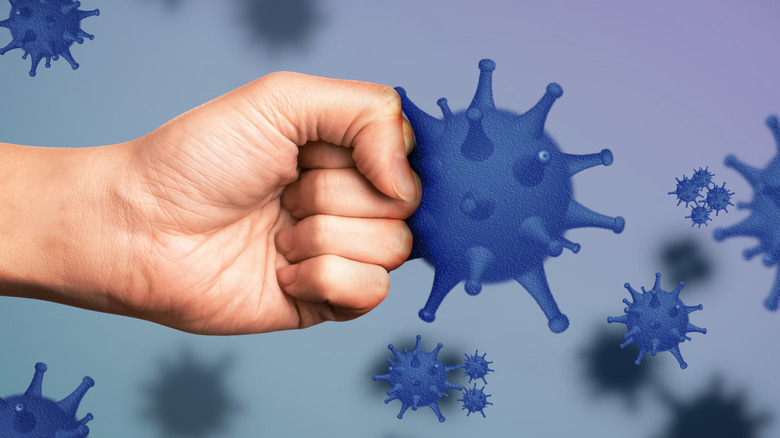 Person punching an illustration of a virus