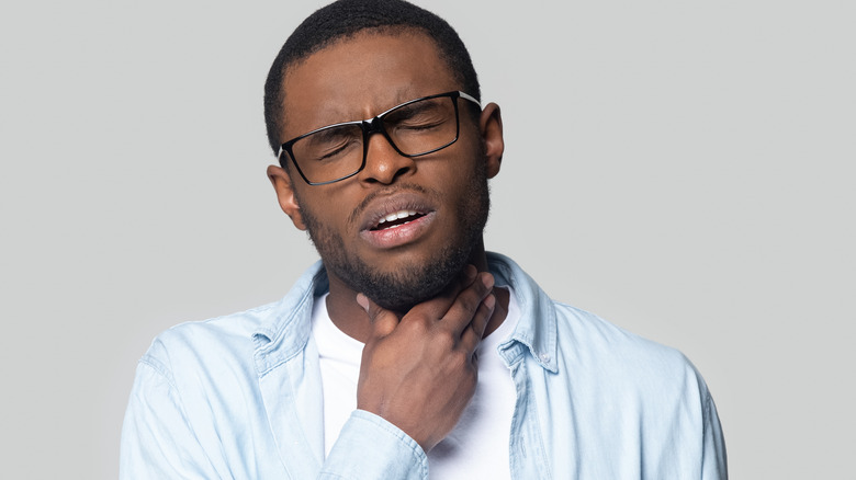 young man with throat irritation