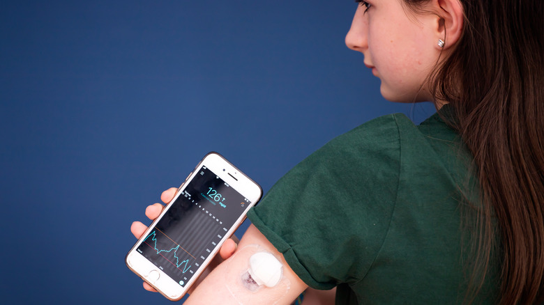 girl with continuous glucose monitor