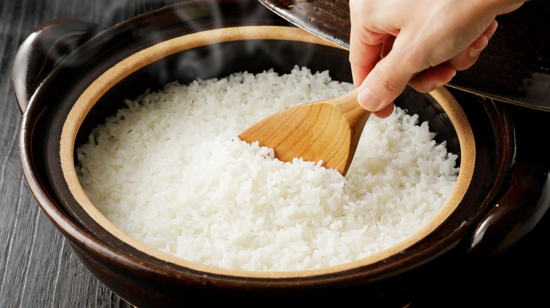 a person scooping out rice