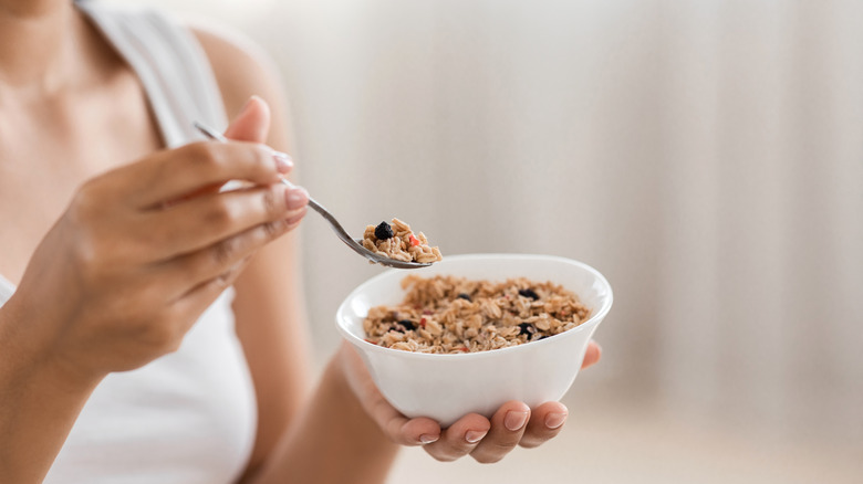 Woman hold a bowl of homemade granola