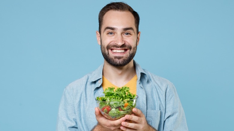 man hold salad bowl