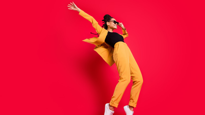 woman wearing orange suit on red background