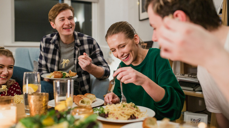 happy people eating pasta