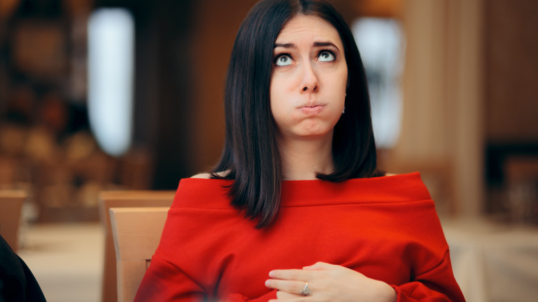 Woman feeling full after breakfast