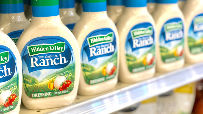 A row of ranch dressing in a grocery store