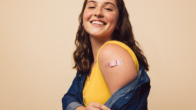 Woman with bandage on upper arm