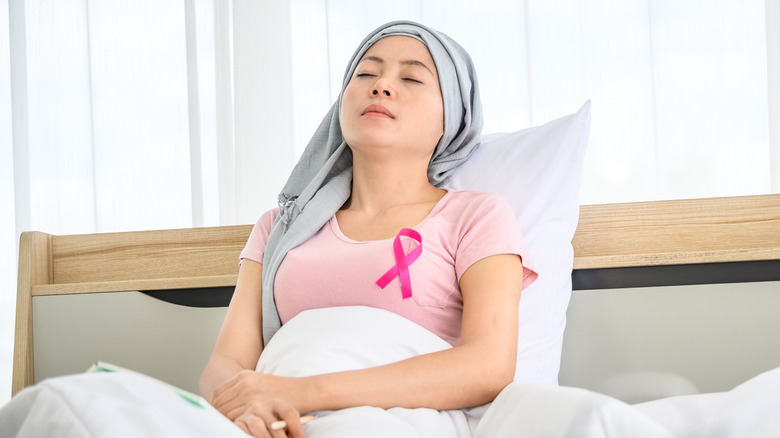 woman in bed with pink ribbon