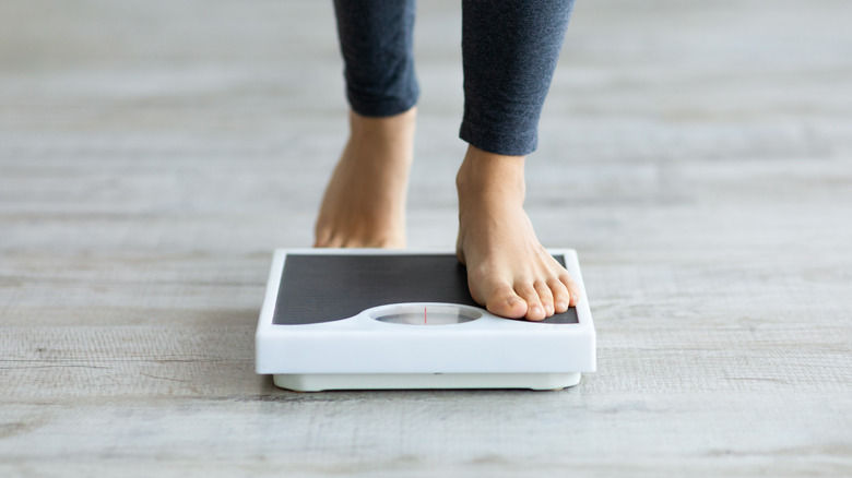 A person stepping onto a scale